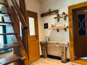 a room with a door and a table and shelves at Bed & Wine Transylvania in Nemşa