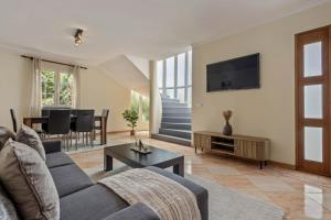 a living room with a couch and a table at Amendoeira Residence by Homie in Quinta do Almeida