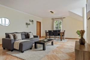 a living room with a couch and a table at Amendoeira Residence by Homie in Quinta do Almeida