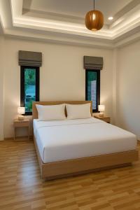 En eller flere senge i et værelse på LOMA Pool Villa