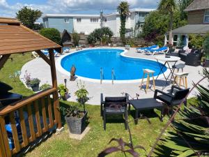 an overhead view of a pool with chairs and a table at The Belmont in Shanklin +54 photos
