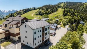 an aerial view of a building in a village at Aux pieds des pistes - Appt B in Ax-les-Thermes