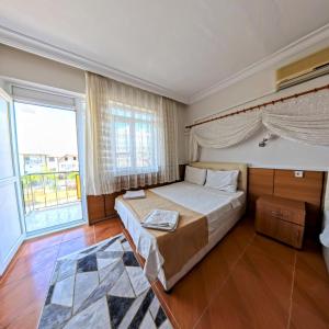 Postel nebo postele na pokoji v ubytování Kervansaray Hotel