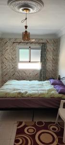 a bedroom with a bed and a window at Grand Appt près de la mer in Hajreien