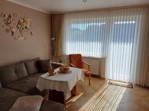 a living room with a couch and a table at Gästehaus Nietmann Ferienwohnung 9 in Altenau