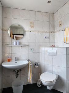 a bathroom with a sink and a toilet at Gästehaus Nietmann Ferienwohnung 9 in Altenau