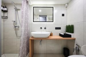 a bathroom with a sink and a shower at Nomad Boutique Hostel - Women Only, Self Check-In, City Centre in Tallinn +39 photos