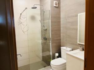 a bathroom with a shower with a toilet and a sink at Douceur de Vie in Praia +14 photos