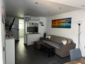 a living room with a couch and a kitchen at Casa Rica in Puerto Rico de Gran Canaria