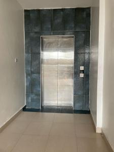 a hallway with a metal elevator in a building at Homes by lucy in Mombasa