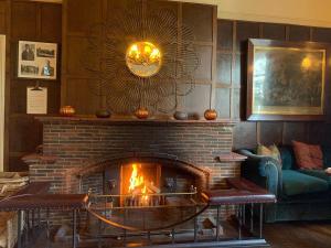 a living room with a fireplace and a couch at The Old Bridge in Huntingdon