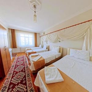 Postel nebo postele na pokoji v ubytování Kervansaray Hotel + 37 fotografií