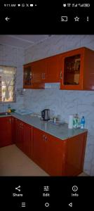 a kitchen with orange cabinets and a counter top at Mama Maya peaceful home in Moshi