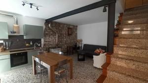 a kitchen and living room with a table and a couch at Casa Vacanze isopep in Lama Di Peligni