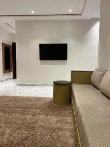 a living room with a couch and a tv on a wall at Nara luxe 3 Berkane in Berkane +36 photos