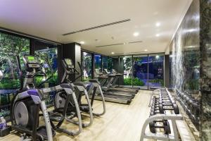 a gym with treadmills and elliptical machines at The Deck Condominium by Lofty in Patong Beach