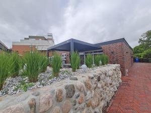 Zahrada ubytování Wilde Brise 3 – Luxusbungalow in bester Lage in Norddeich