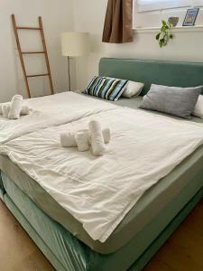 a large bed with two white pillows on it at Appartement nähe Gruga-Messe und Klinik! in Essen