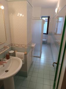 a bathroom with a sink and a toilet and a mirror at Villa Calù in Casamicciola Terme +20 photos