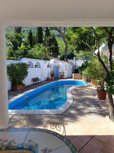 a swimming pool in front of a house at Villa Calù in Casamicciola Terme