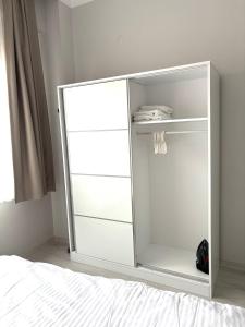 a white cabinet with a mirror in a bedroom at Sevez Apartments & Homes in Gelibolu