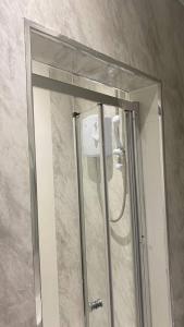 a shower with a mirror in a bathroom at Contemporary Private Bedroom Retreat in Sheffield