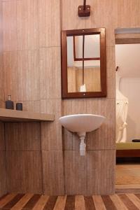 a bathroom with a sink and a mirror at Indra Valley Inn Bukit Lawang in Bukit Lawang