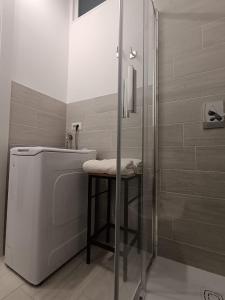 a bathroom with a shower and a stool next to a toilet at La Cornice nel Centro-502 in Varese +31 photos