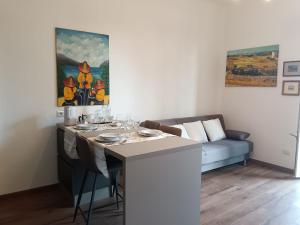 a living room with a table and a couch at La Cornice nel Centro-502 in Varese