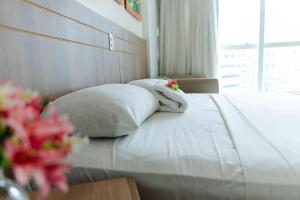 巴西利亚SM1116 Apart Hotel em andar alto região central的一间卧室，配有一张床、两个枕头和一扇窗户 更多29张照片