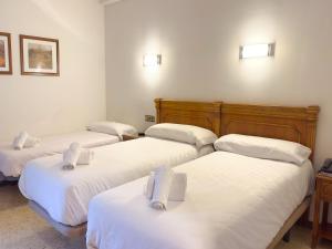 Voodi või voodid majutusasutuse Hotel Pere D'Urg 3000 toas