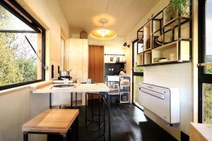 a small kitchen with a island in a tiny house at PATiny Lodge in Augerolles