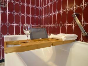 a bath tub with a glass of wine and a table on it at 150 m 5-room Villa 15 min to Düsseldorf in Kaarst