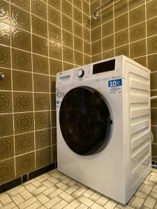 a white washing machine sitting in a bathroom at 150 m 5-room Villa 15 min to Düsseldorf in Kaarst