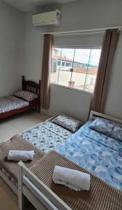 Postel nebo postele na pokoji v ubytování Linda Casa 2 qrts Churrasqueira garagem Resende RJ