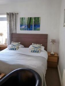 a bedroom with a bed with two pillows on it at The Lakes B and B in Ambleside