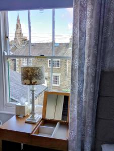a desk with a mirror in front of a window at The Lakes B and B in Ambleside