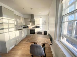 a kitchen with a table and chairs and a window at Essex Studio Retreat Flat 4 in Chelmsford