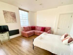 a living room with a bed and a couch at Essex Studio Retreat Flat 4 in Chelmsford