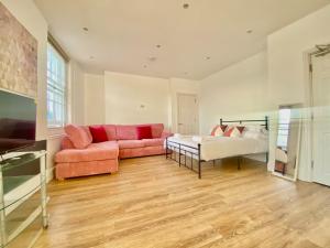 a living room with a couch and a bed at Essex Studio Retreat Flat 4 in Chelmsford