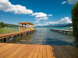 un molo in legno con gazebo sull'acqua di feel good Resort a Krumpendorf am Wörthersee