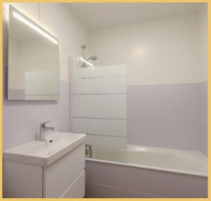 a white bathroom with a sink and a mirror at Le Cyclade I Studio I Saint-Julien in Saint-Julien-en-Genevois +21 photos