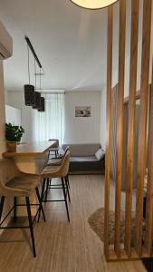 a living room with a table and chairs and a couch at Apartman Iris in Karlovac