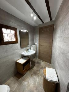 a bathroom with a sink and a toilet at Alojamiento Turístico Mirador del Castillo in Bedmar +31 photos