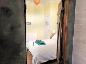 a bedroom with a bed and a mirror at Room with luxury private bathroom & independent entrance near Tube in London +10 photos