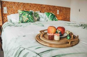 a tray of fruit and candles on a bed at Apartamento Jacuzzi La Manga - Primera Linea in La Manga del Mar Menor