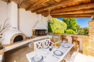 an outdoor patio with a table and an outdoor oven at Villa Noulia in Kynopiástai