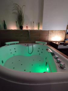 a green bath tub in a room with aperature at Apartamento Jacuzzi La Manga - Primera Linea in La Manga del Mar Menor