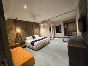 a hotel room with a bed and a couch at Western Banjara in Hyderabad