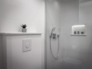 a white bathroom with a shower with a glass door at Apartments Roberta in Novigrad Istria +123 photos